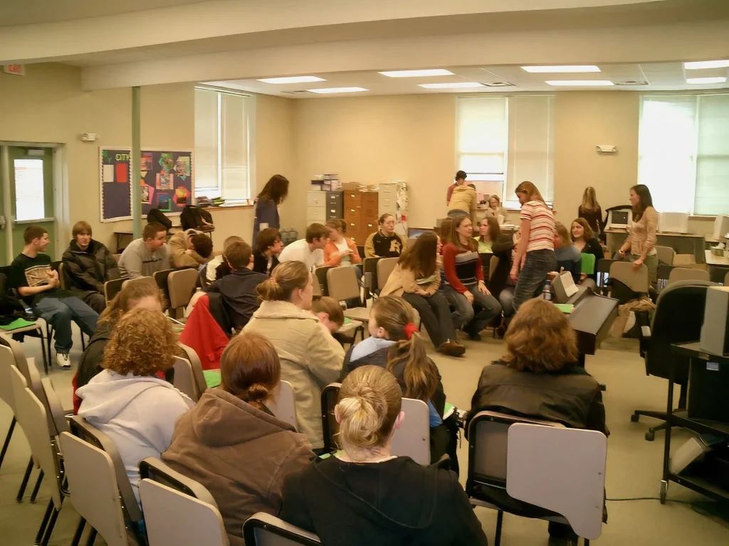 Students and their teacher inside a public high school classroom in the United States.