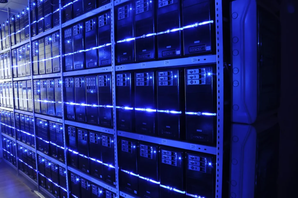 Rows of server racks inside a large data centre that powers cloud and AI services.