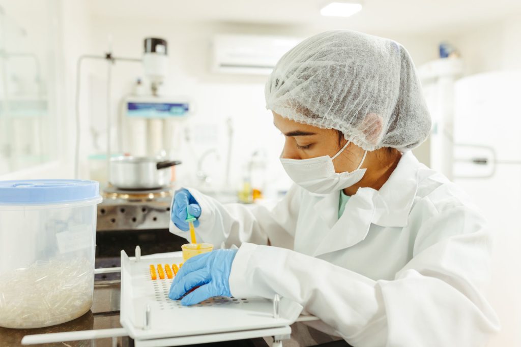 A Personalised Cancer Vaccine, Explained Simply and Carefully Researcher holding a vaccine vial in a medical laboratory
